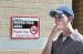 Nick Hanson takes a drag outside Stewart Hall in front of one of the newly erected no-smoking signs on campus.